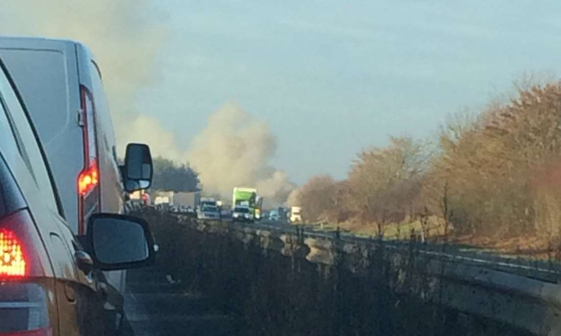 Smoke can be seen pouring across the carriageway. Picture: Adam Dench