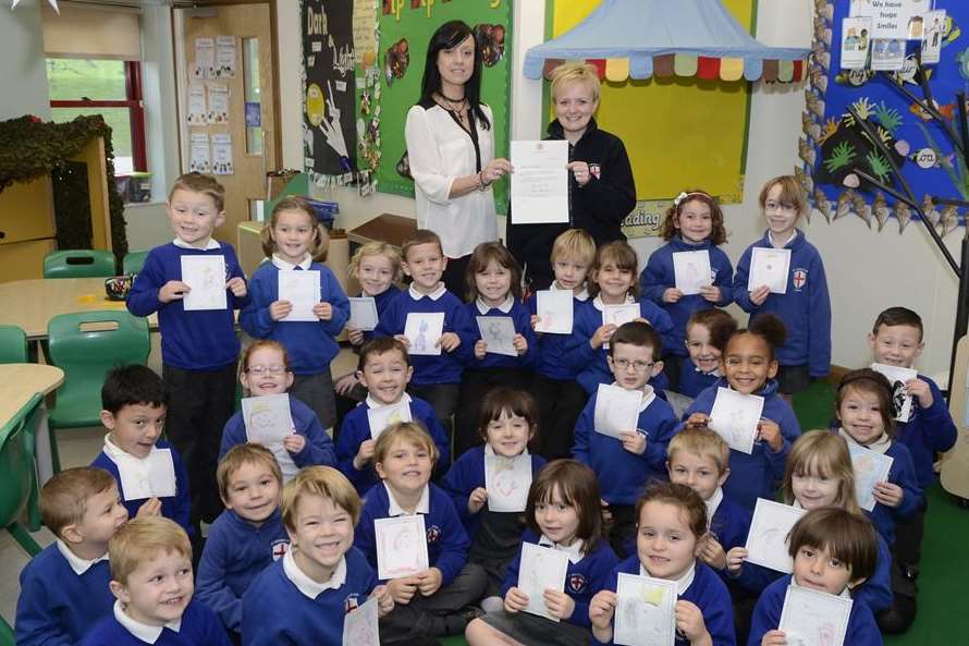 Teacher, Tracy Adlam and teaching assistant Teresa Issitt with Beech Class and their stamp designs for the Queen