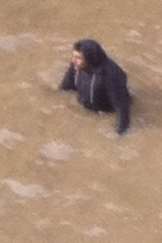 Man awaits rescue after falling into the River Thames. Picture: Phil Murfin