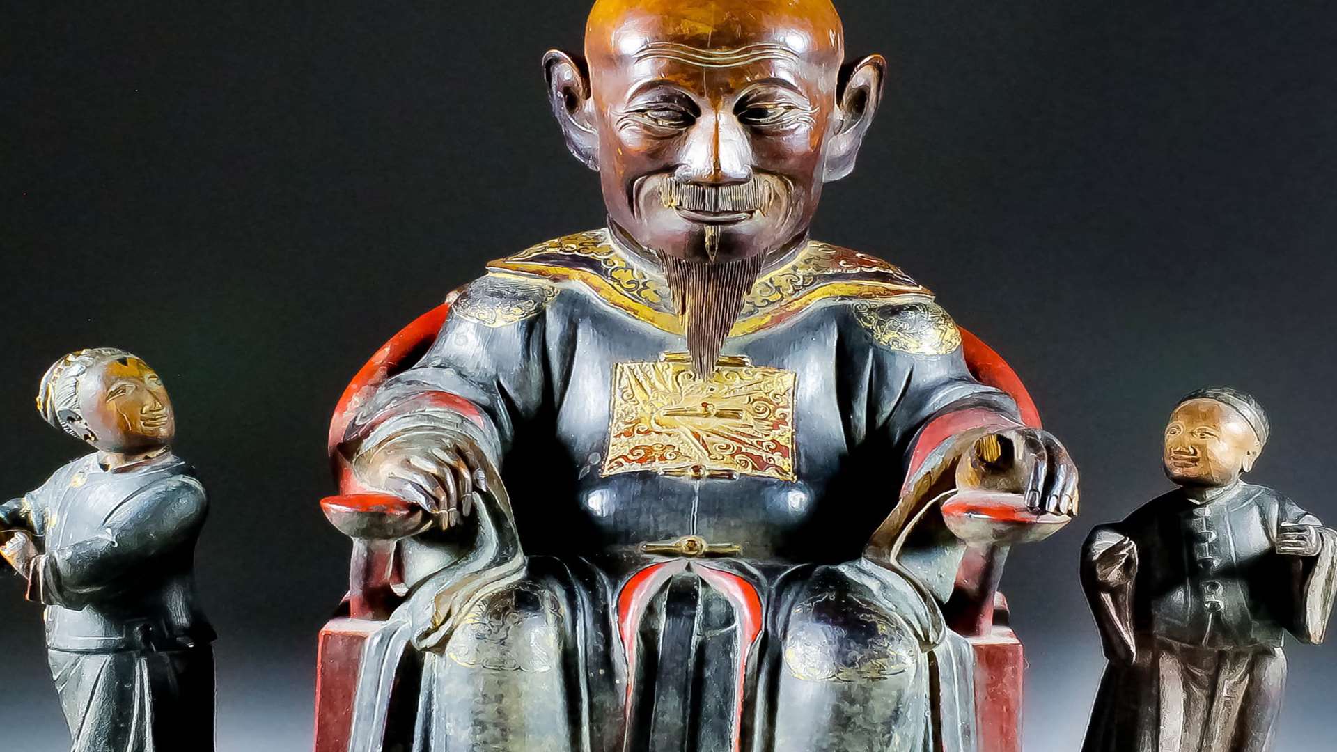 A Chinese carved and lacquered giltwood figure of a Mandarin
