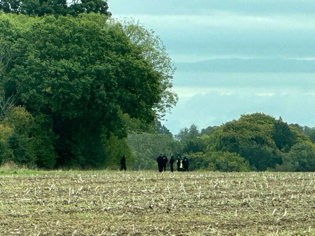 A team of officers scouring a field in Eastling. Picture: Brian Flynn