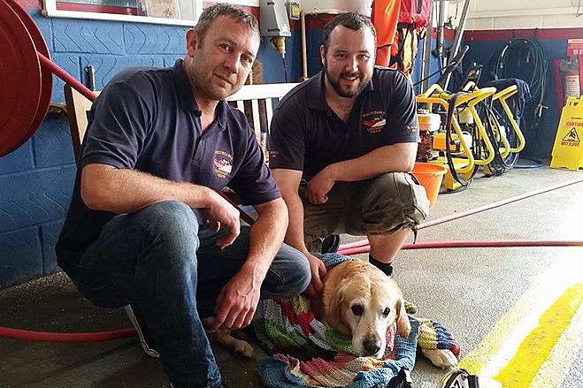Lifeboat crew members Richard Curtis and Dan Monk with Drum after the rescue. Picture: Whitstable RNLI