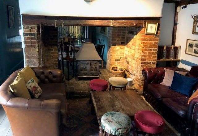 The small double-doored wood burner sits elegantly in a double-sided fireplace. I could definitely see myself in one of these armchairs with a pint before Sunday lunch.