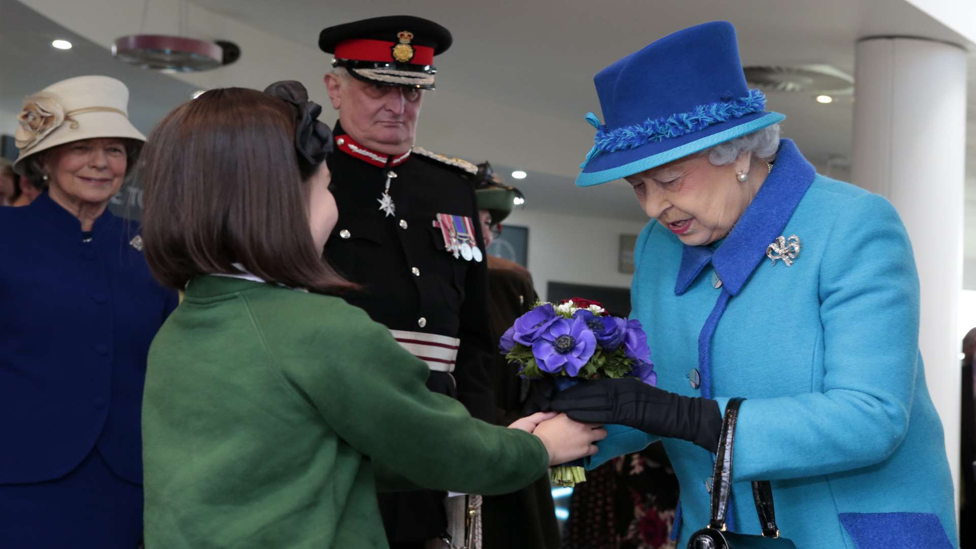 Her Majesty received a posy from Scarlett Stevens from Capel le Ferne Primary School