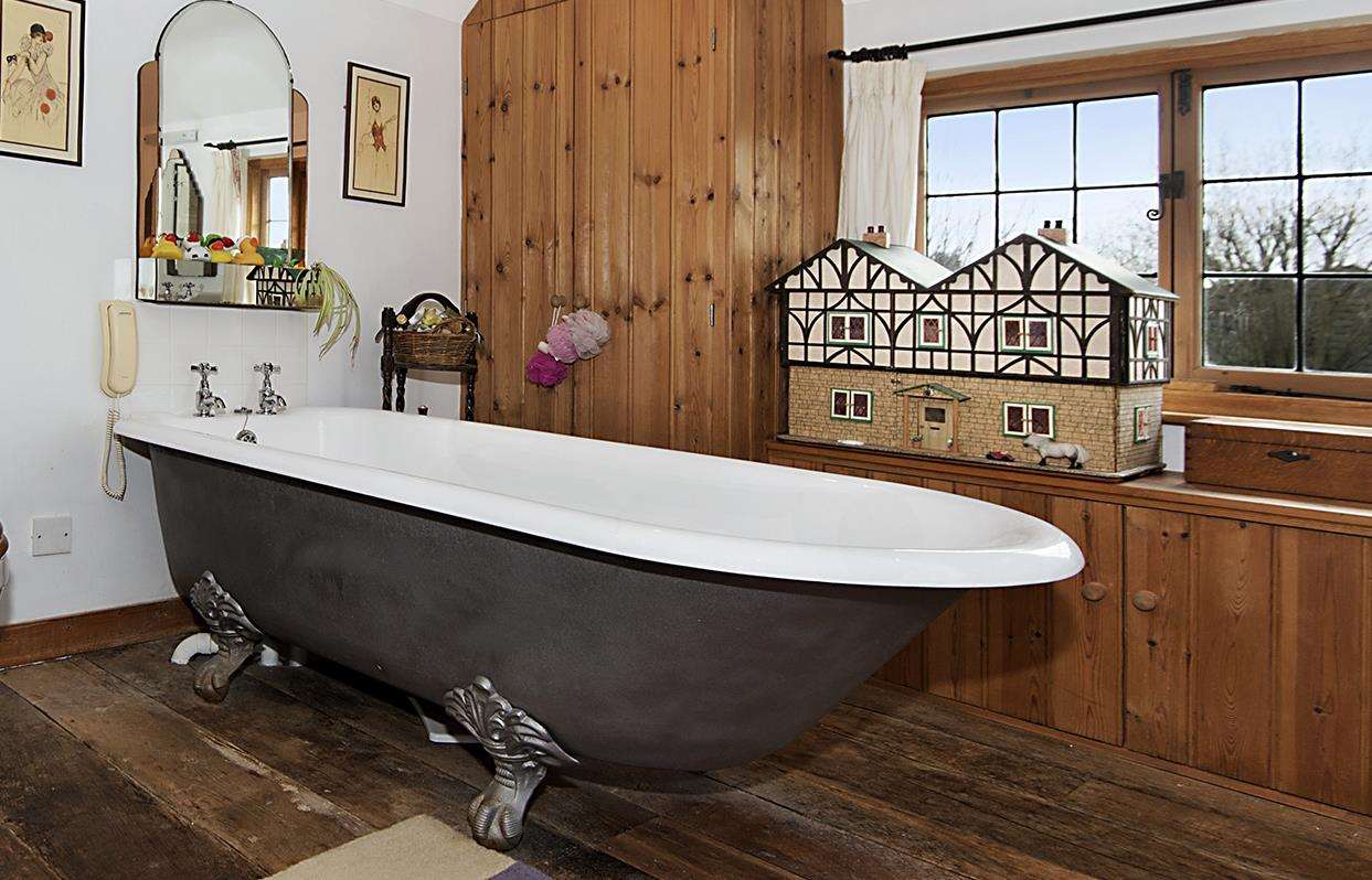 The large en suite has a roll-top bath