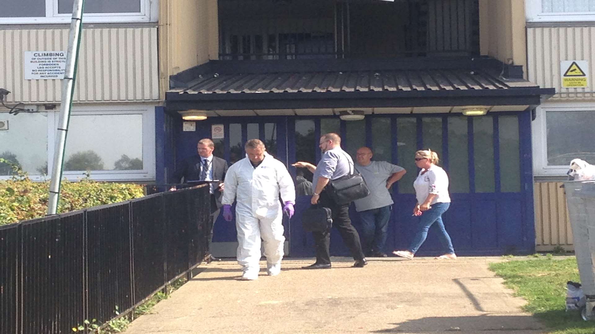 Forensics officers leaving the murder investigation scene in Shipwrights Avenue