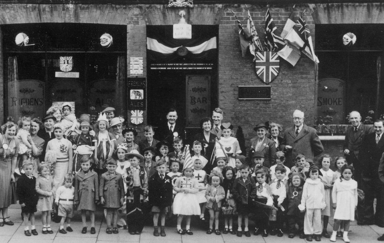 Children in their best clothes enjoying coronation events in Ospringe Road, Faversham