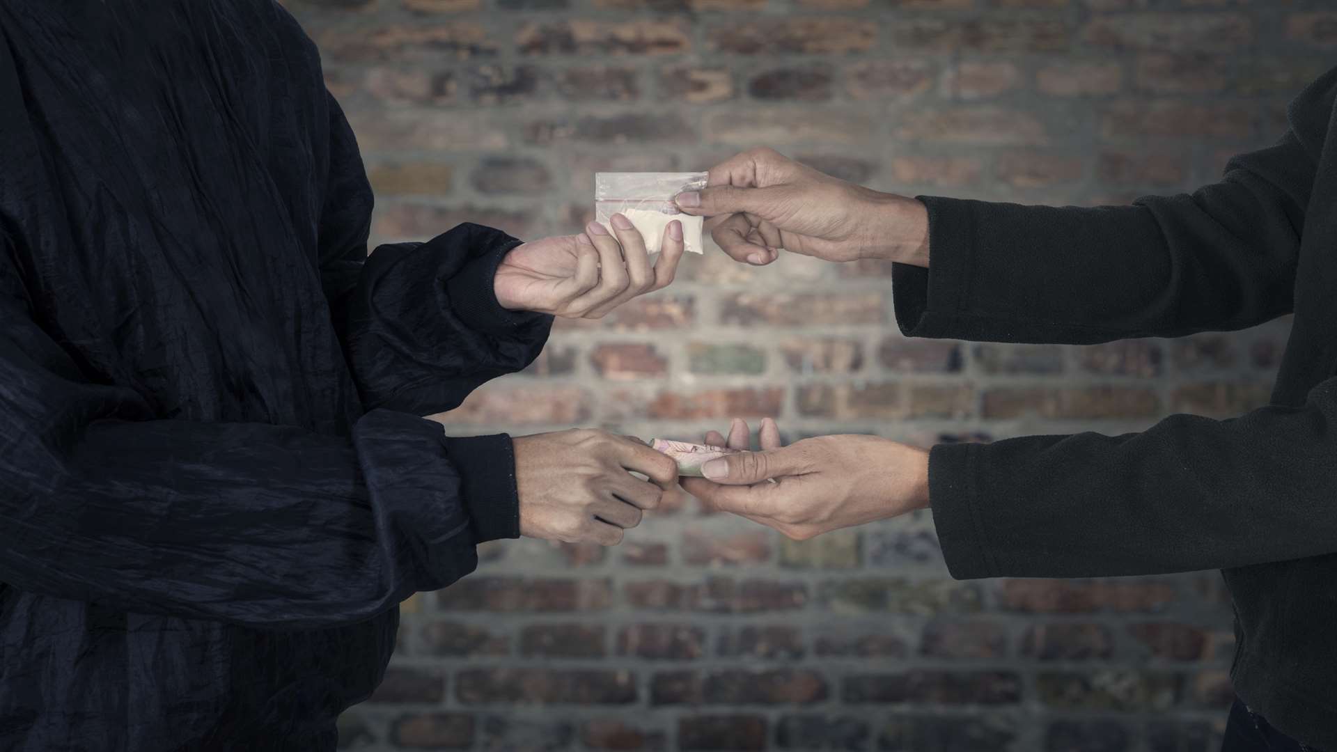 Drug dealer taking money for heroin. Stock image