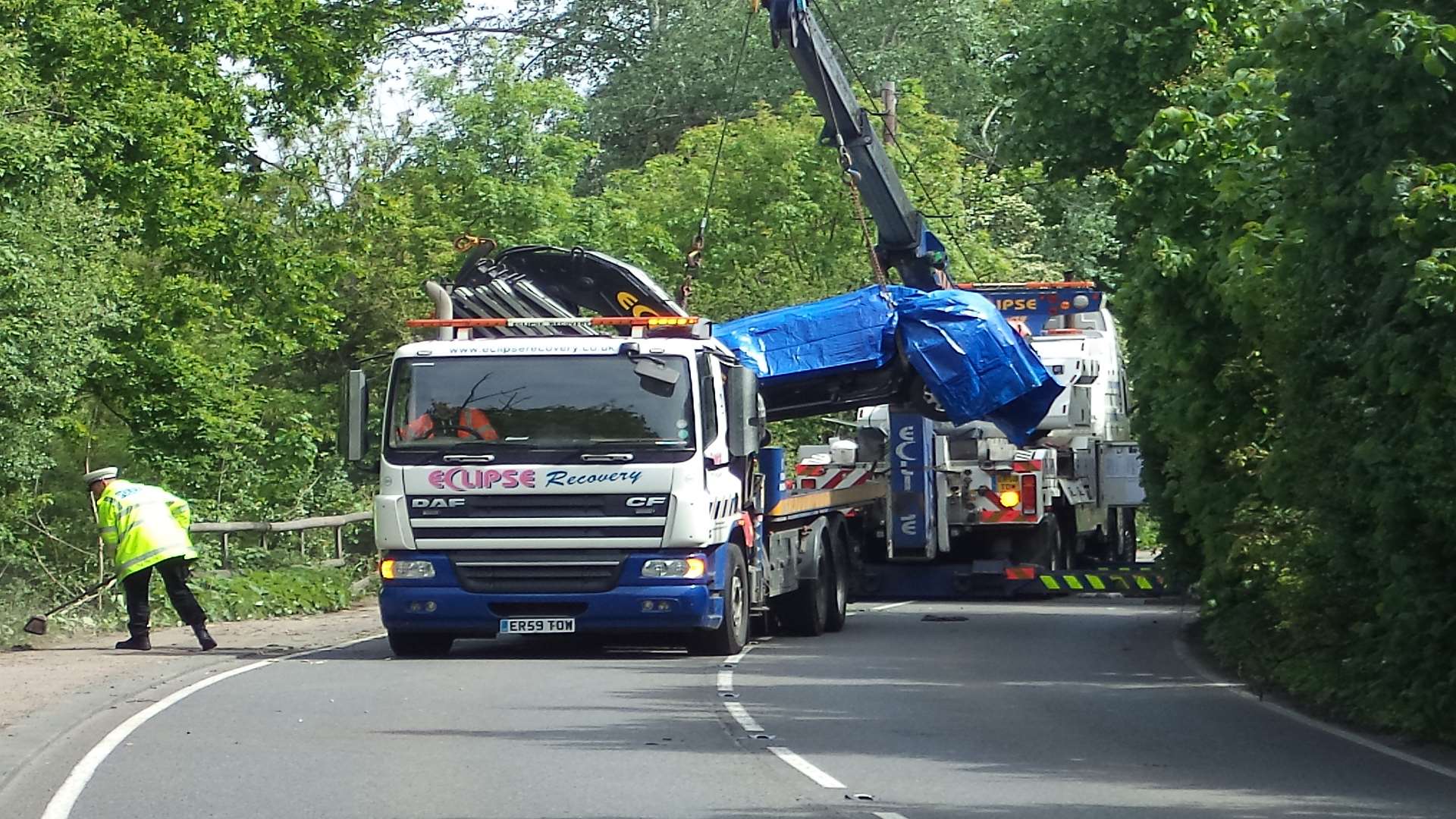 The car is taken away by recovery crews