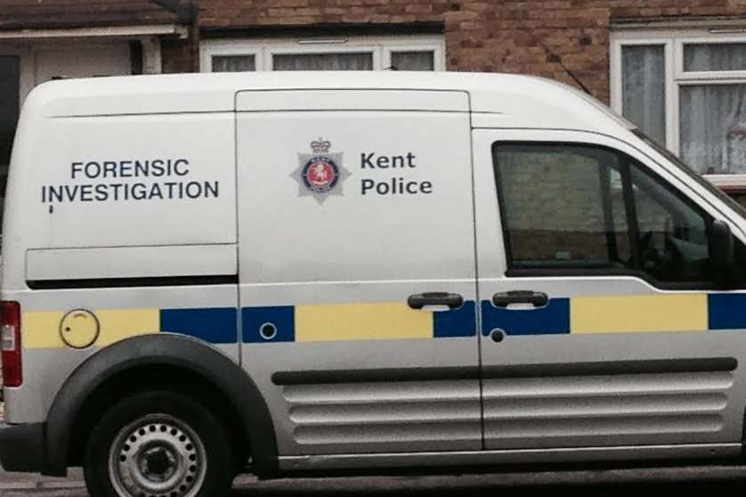 A police forensics van parked outside the house