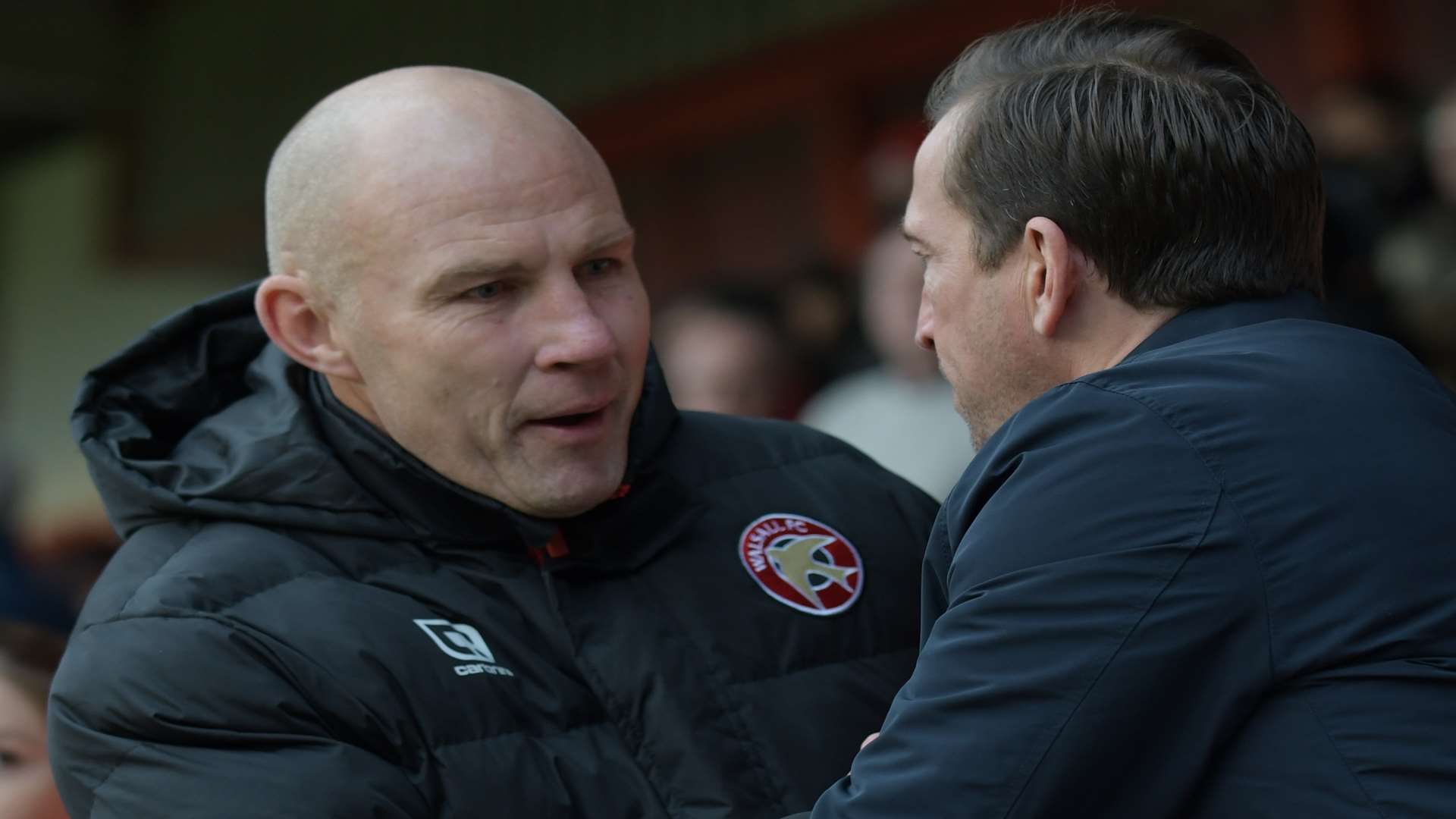 Walsall manager Jon Whitney and former Gills boss Justin Edinburgh shake hands before the last meeting Picture: Barry Goodwin