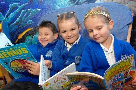 Nojus, six, Kacey and Mia, both five, from Milton Court School delve into a selection of books at Sittingbourne Library
