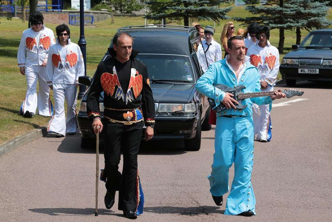 Funeral directors Rafael Learmonth and Ashley Sutton lead the procession at Frank Kerr's Elvis-themed funeral