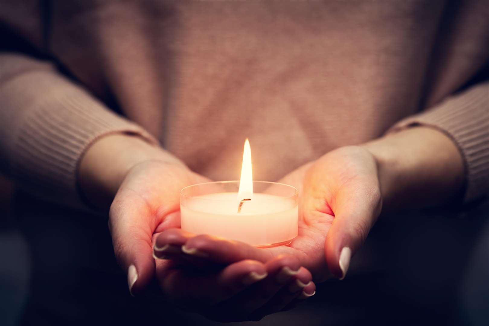 Candle light glowing in woman's hands. Praying, faith, religion concept.. (6172585)
