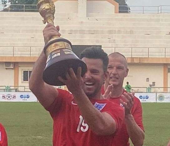 Jamie Coyle lifts the Seniors World Cup after helping England beat Iran