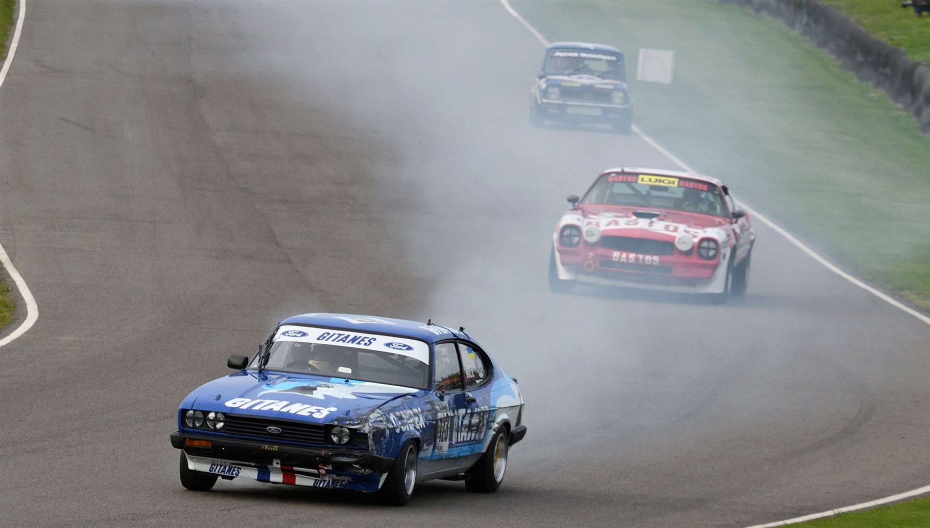 Smoke pours from Jake Hill's car, as he leads the start of the Gordon Spice Trophy final. Picture:Simon Hildrew