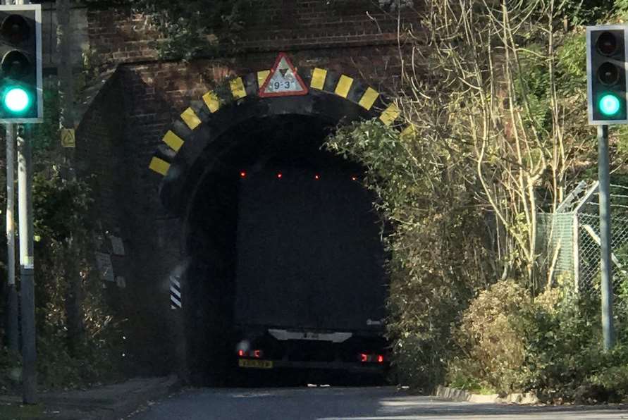 The lorry is stuck under the railway bridge.