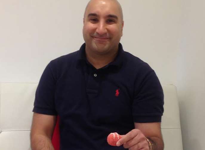 Satinder Kang, owner of Barfia Gravesend, with a pink sweet
