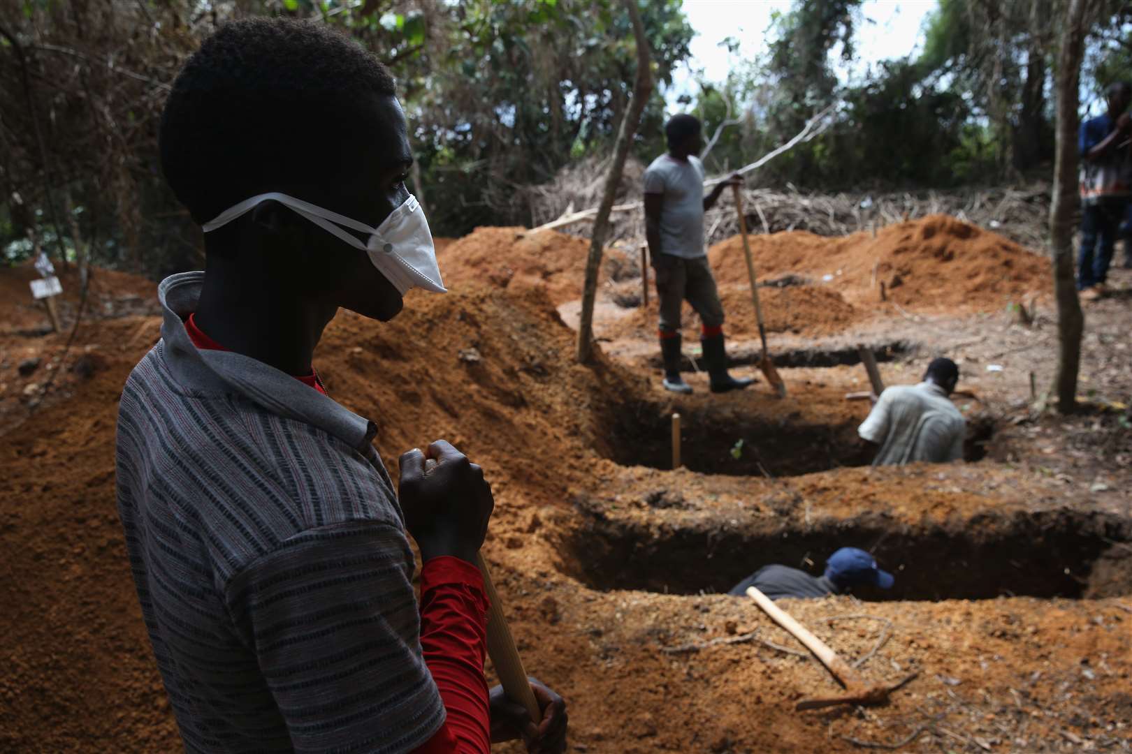Grave diggers prepare for new Ebola victims outside an Ebola treatment centre. Picture: John Moore/Getty Images