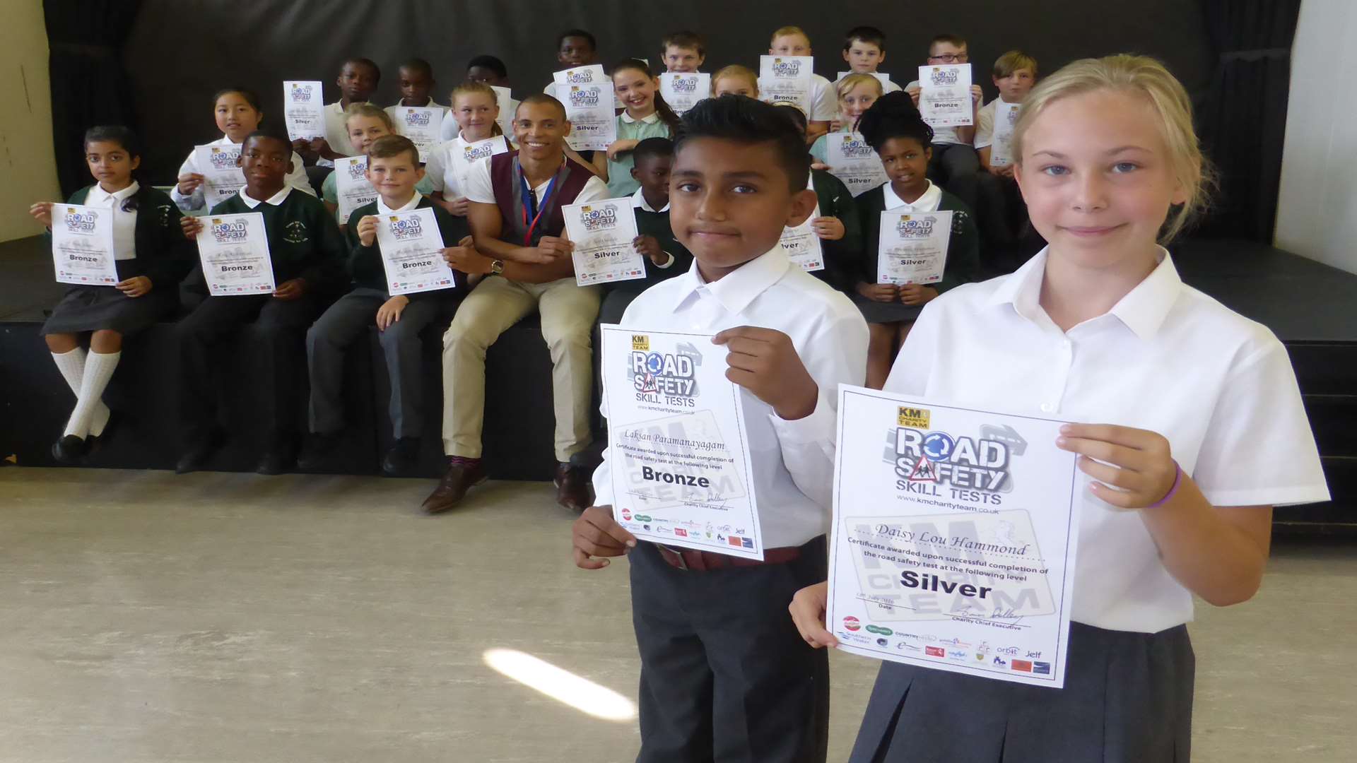 Laksan Paramanayagam and Daisy Lou Hammond and Year 6 pupils from Gravel Hill Primary School, Bexley celebrate passing their road safety skill tests.