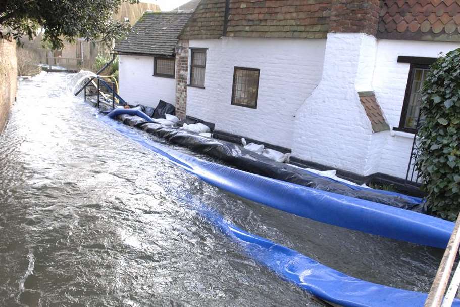 Pipes leading from pumps and into the swollen Nailbourne in Bridge. Picture: Chris Davey