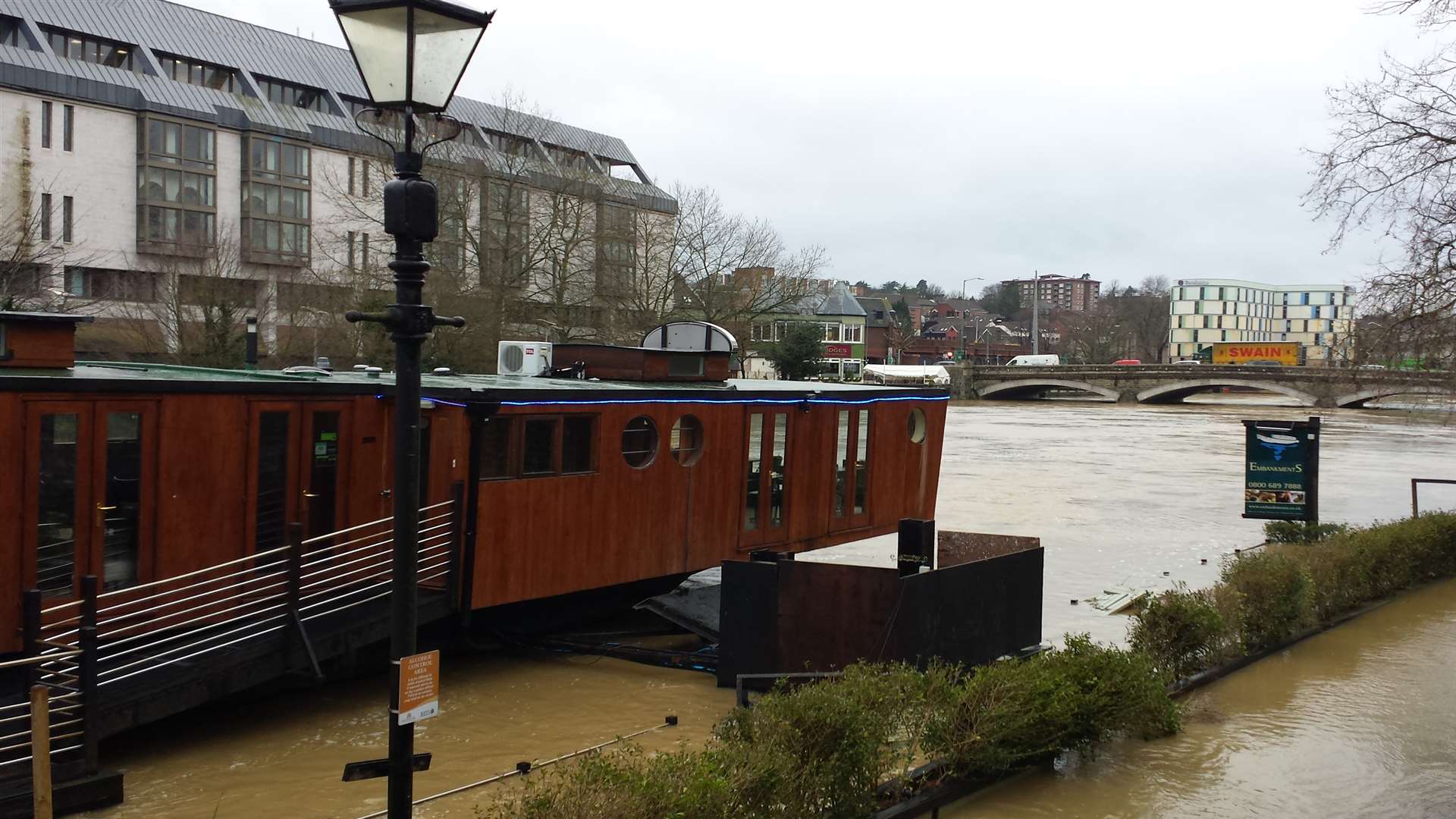 Pathways disappear under the swollen river in Maidstone