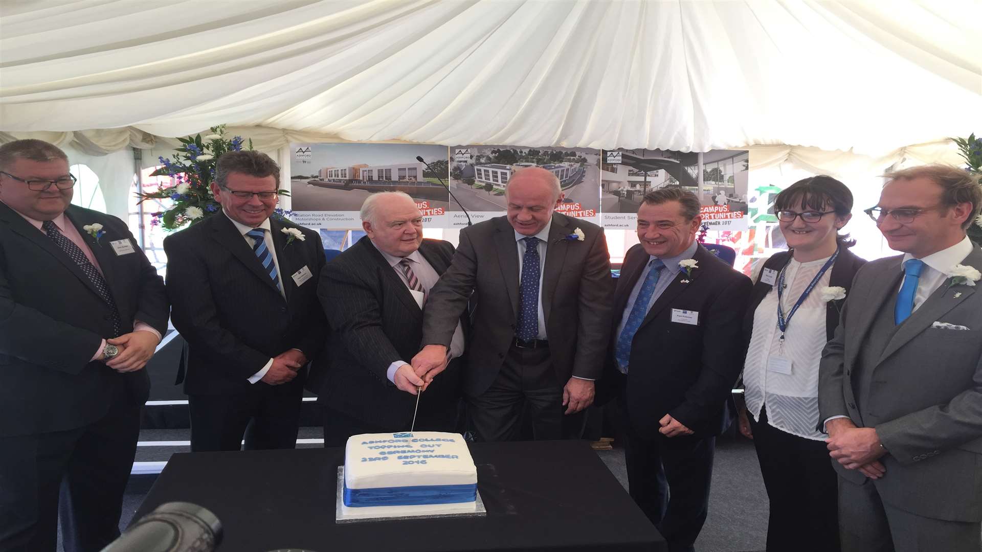 Cllr Gerry Clarkson and MP Damian Green cut the cake with the Hadlow Group and BAM Construction teams.