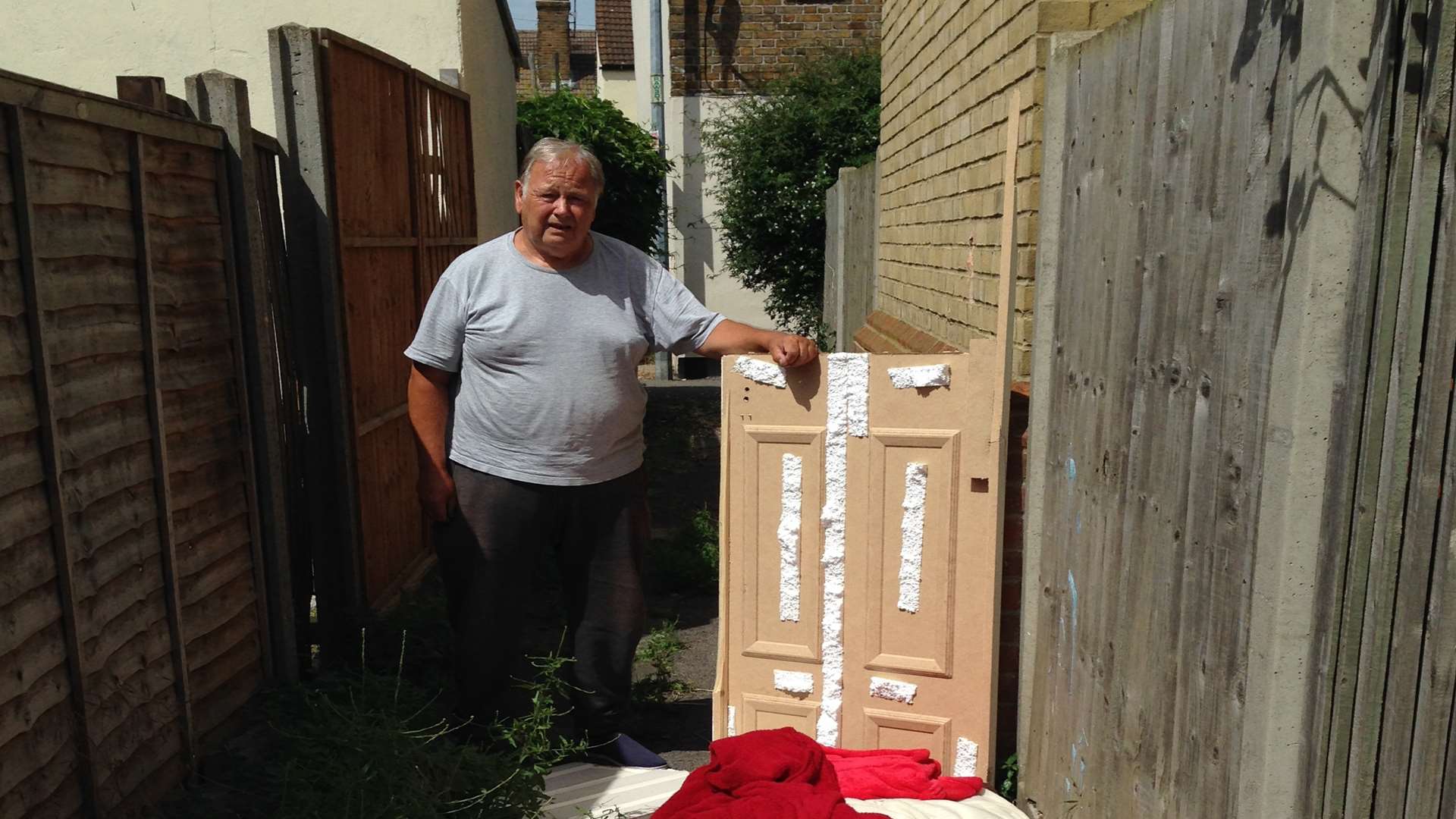 Peter Demoore, of Richmond Street, Sheerness, with illegal waste dumped waste in the alleyway behind his home.