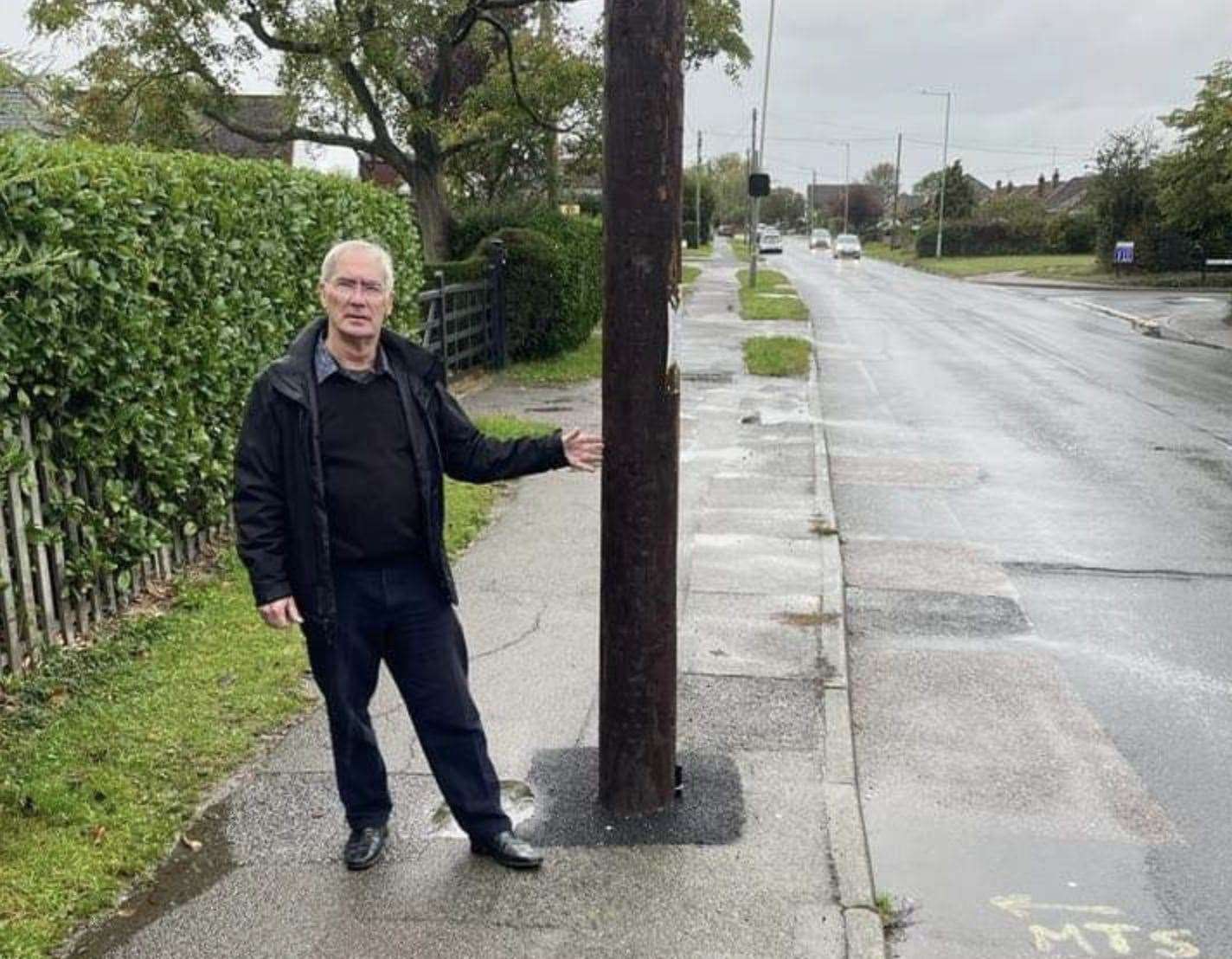 Steve Tragner of Whitstable with the telegraph pole outside his home which caused the sewage problems