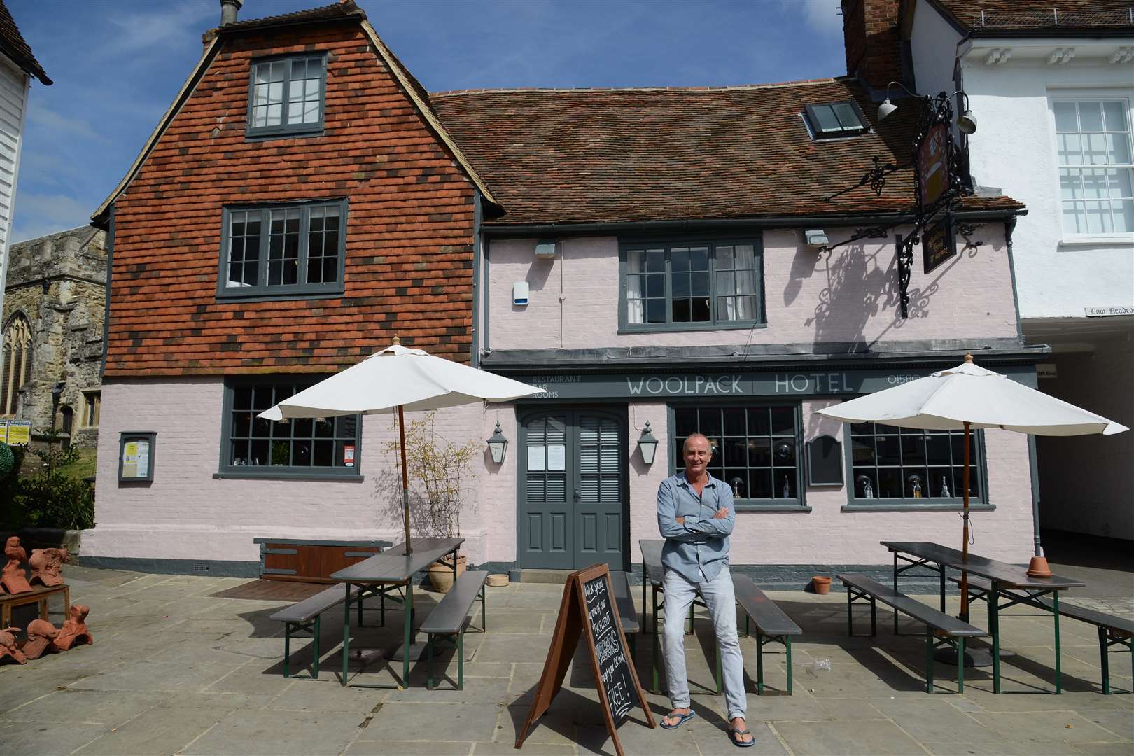 Landlord Rob Cowan outside The Woolpack Hotel in Tenterden which he has painted pink