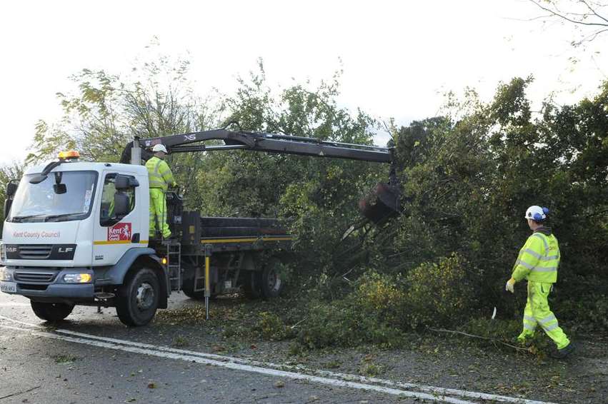 Emergency workers clear a fallen tree blocking the A2 near Ospringe