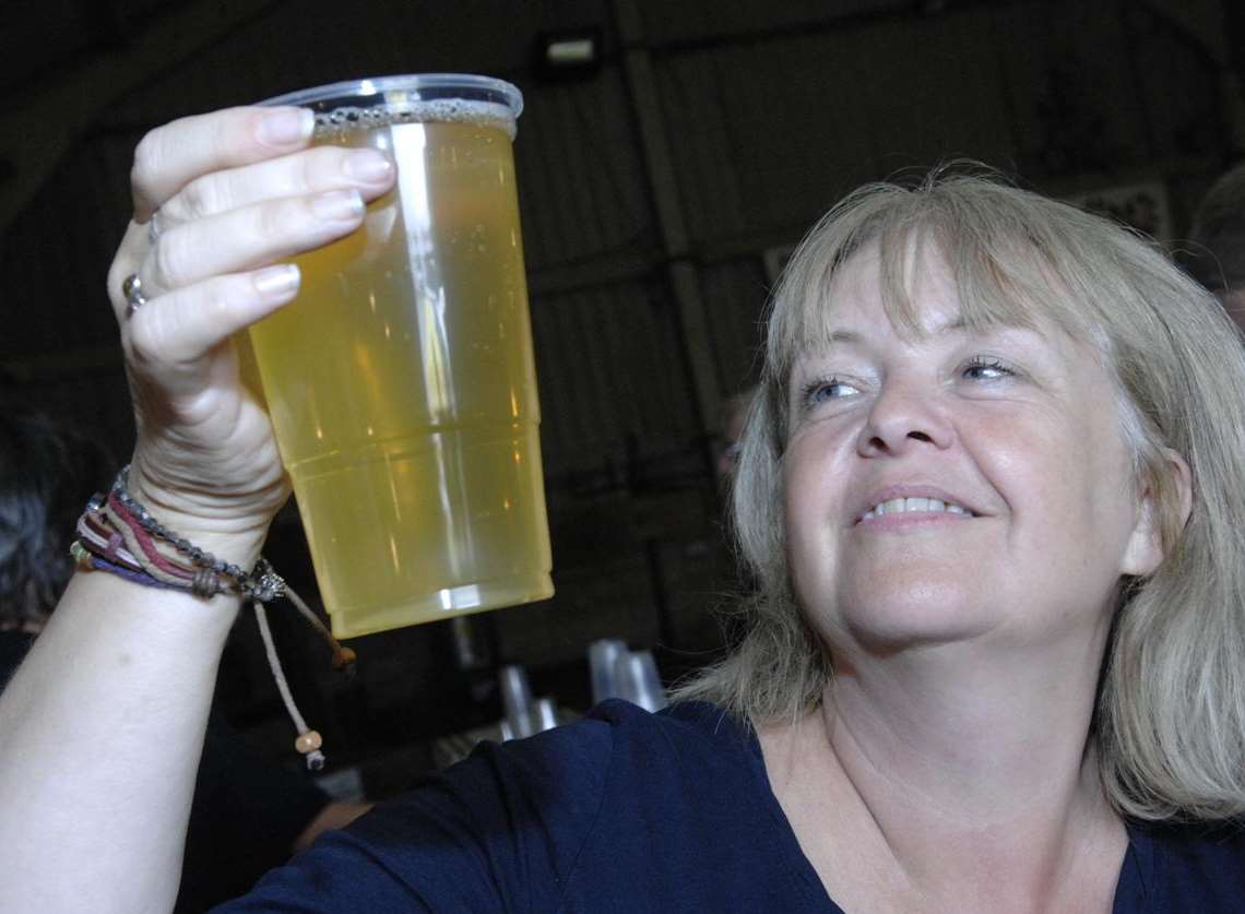 Debbie Hickman of Tiddly Pomme checks out a glass of Woolly Pig cider