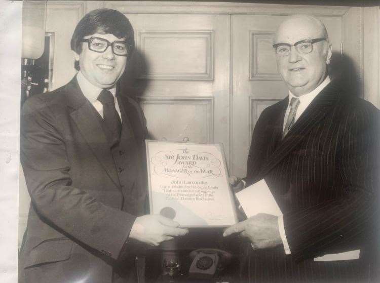 John Larcombe, left, being given one of his many rewards