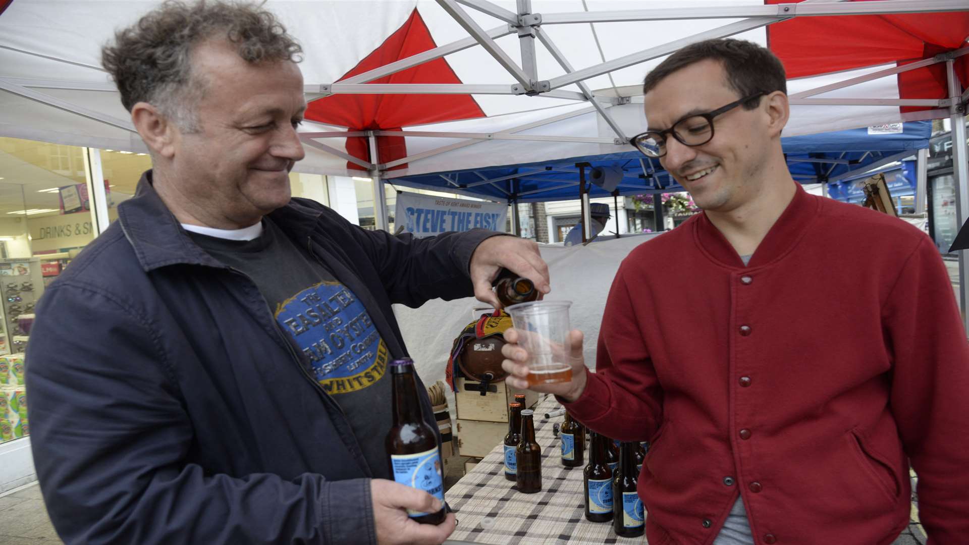 Martin Convery of Turnstone Brewery pours a sample of his beers for Rob Fordham at the Faversham Food Festival on Saturday.