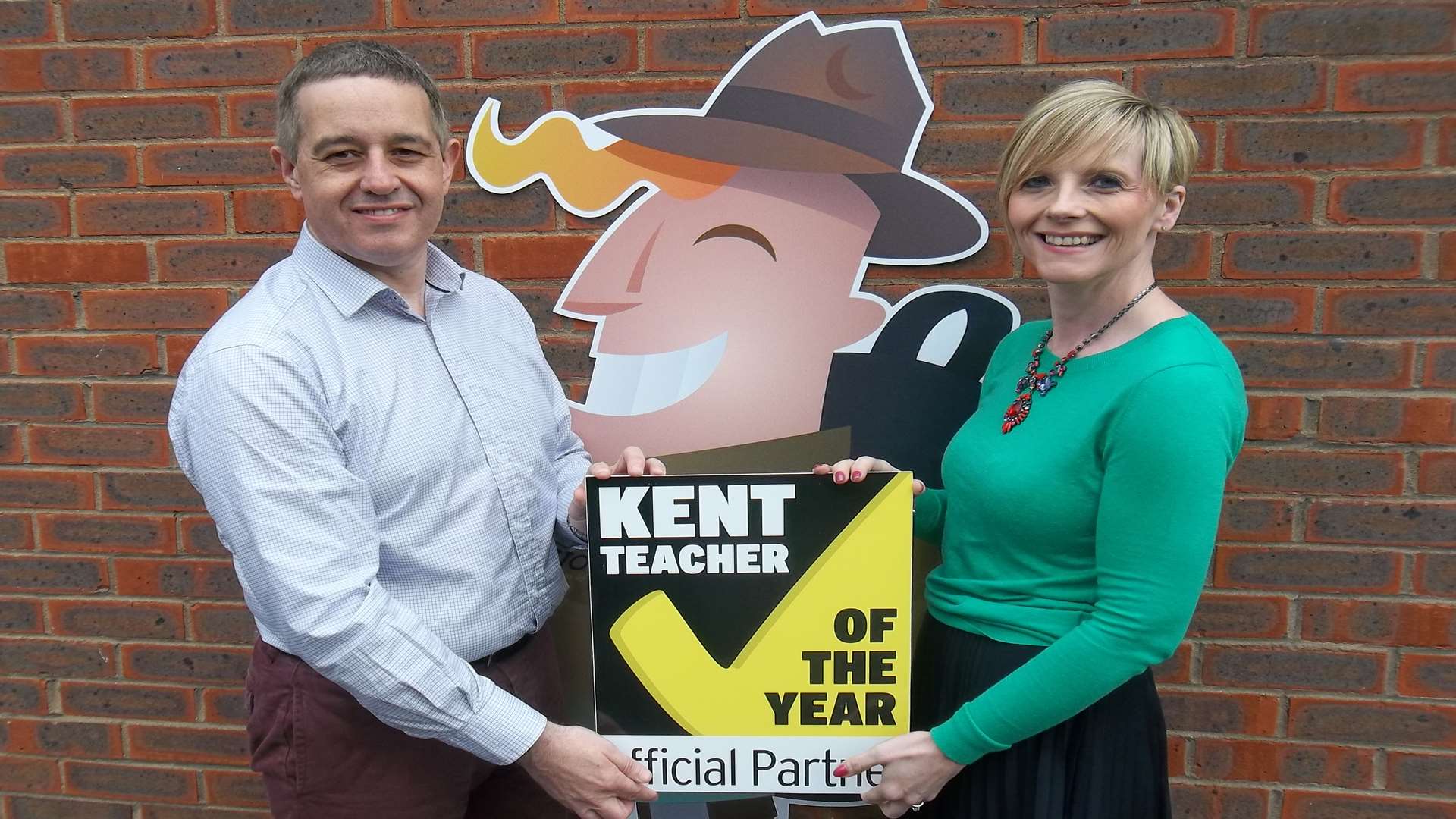 Andrew and Rita Lawrence from Questor Insurance, with company mascot Quentin Questor, are supporting the Kent Teacher of the Year Awards