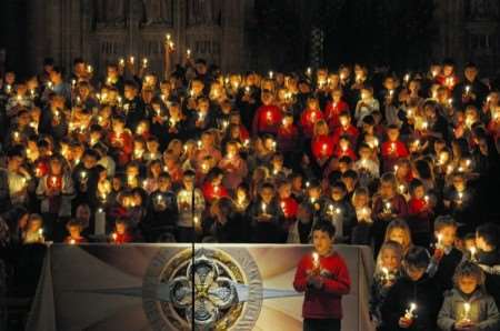 Children and their candles on the steps behind the altar at the Christingle service. Picture: Paul Amos