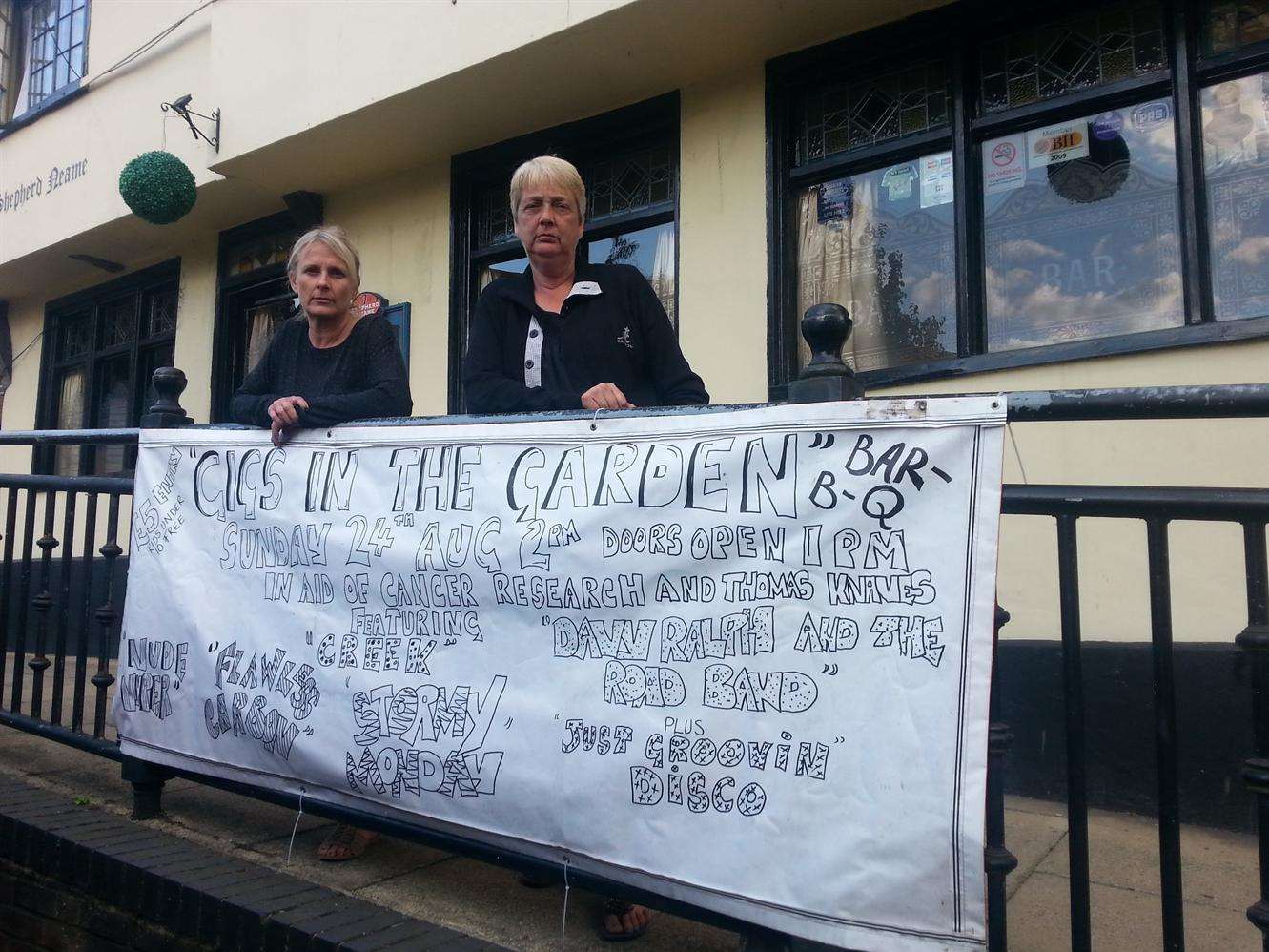 Landlady Sara Apps and regular Julie Knaves next to the banner. Picture: Bess Browning