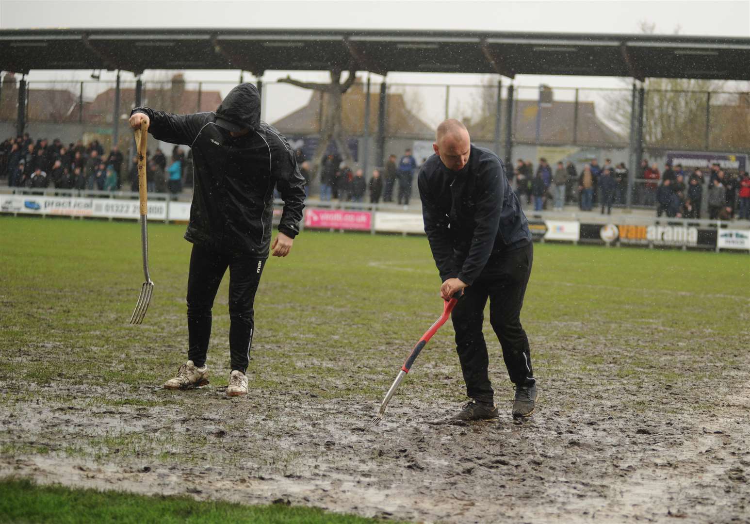 Dartford's ground staff work on the pitch during half-time Picture: Steve Crispe