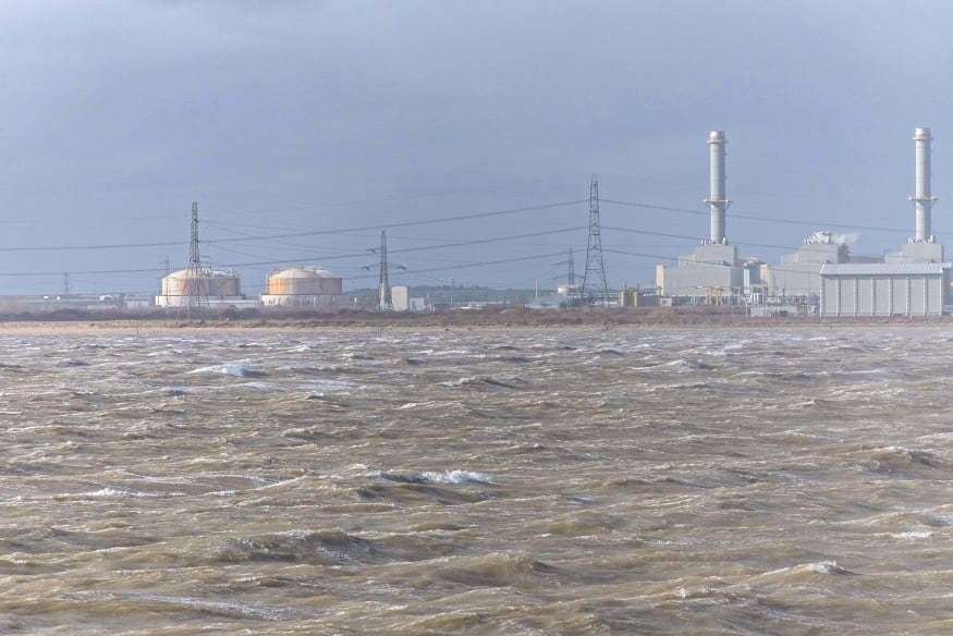Gone: two chimneys at the power station on the Isle of Grain remain thanks to Storm Eunice on Friday. Picture: James Hughes