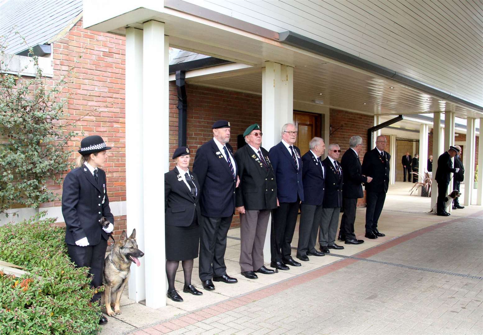 A Guard of Honour from the Kent Police Dog Unit and members of the Royal Navy Ass for Mick Bingham's Funeral on arrival at the Garden of England Crematorium, in Bobbing. Picture: Roger Vaughan
