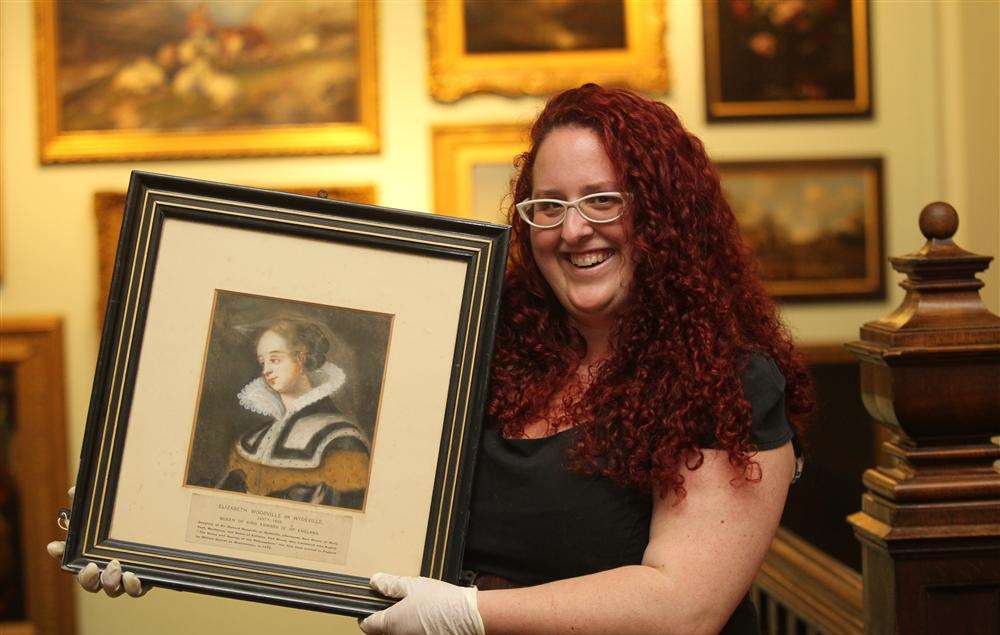 Samantha Harris, Collections Officer at Maidstone Museum holds up a portrait of Elizabeth Woodville