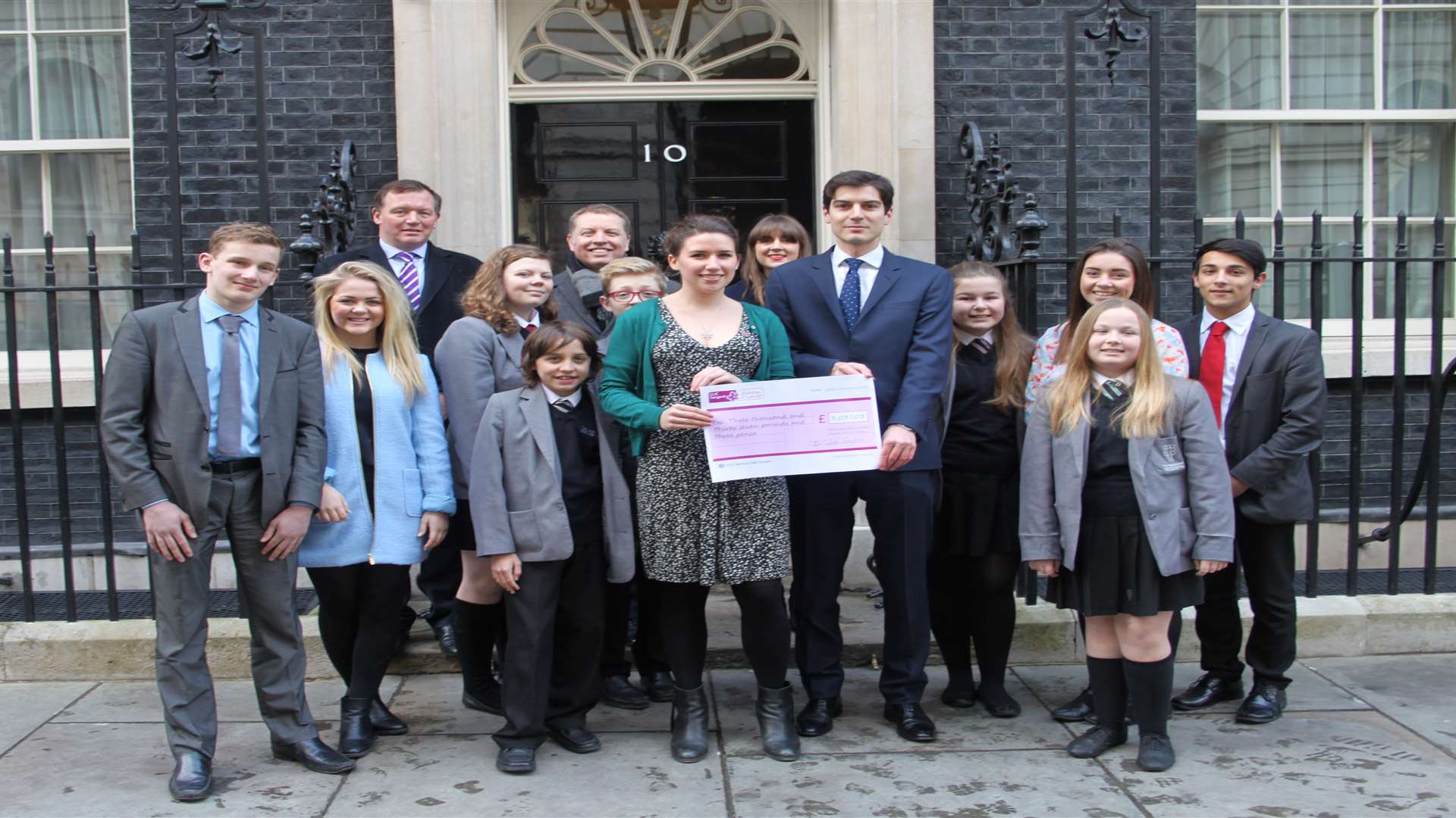 The youngsters outside Number 10 as part of their Westminster Wig Wiggle met up with Damian Collins MP (back left). Picture: CLIC Sargent
