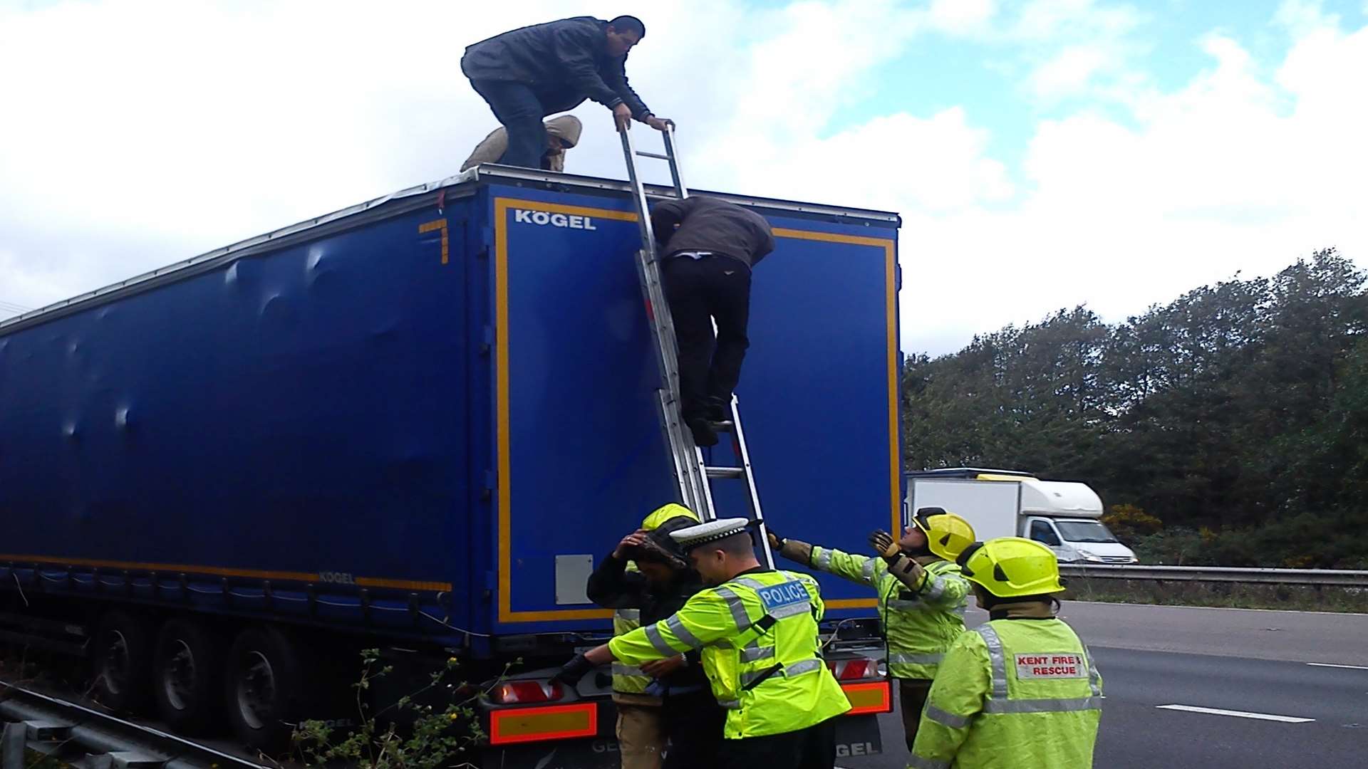 Firefighters helped the men down from the top of the lorry. Picture: Andy Rickwood