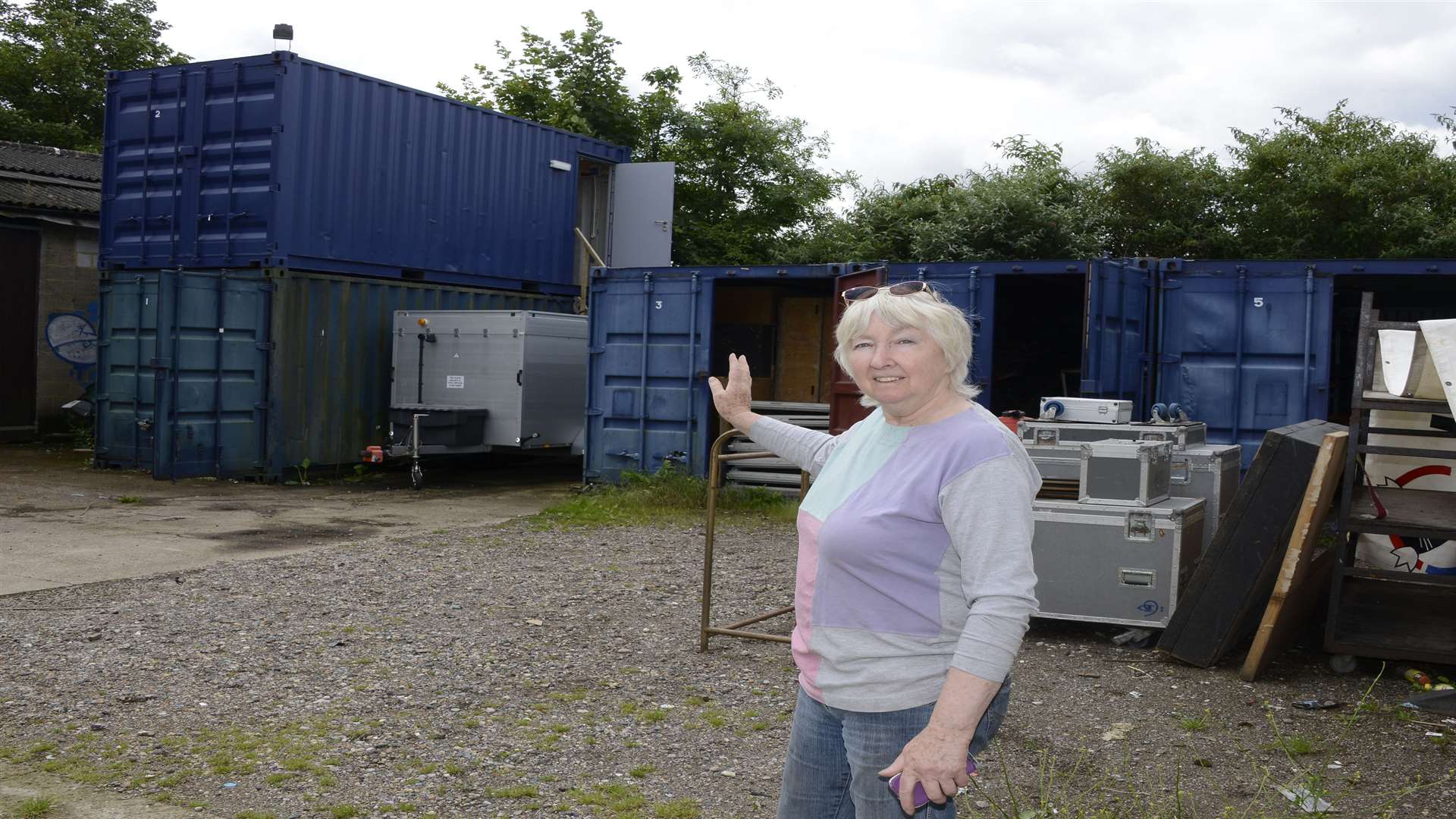 Stella Critchley with the shipping containers holding the theatre's belongings