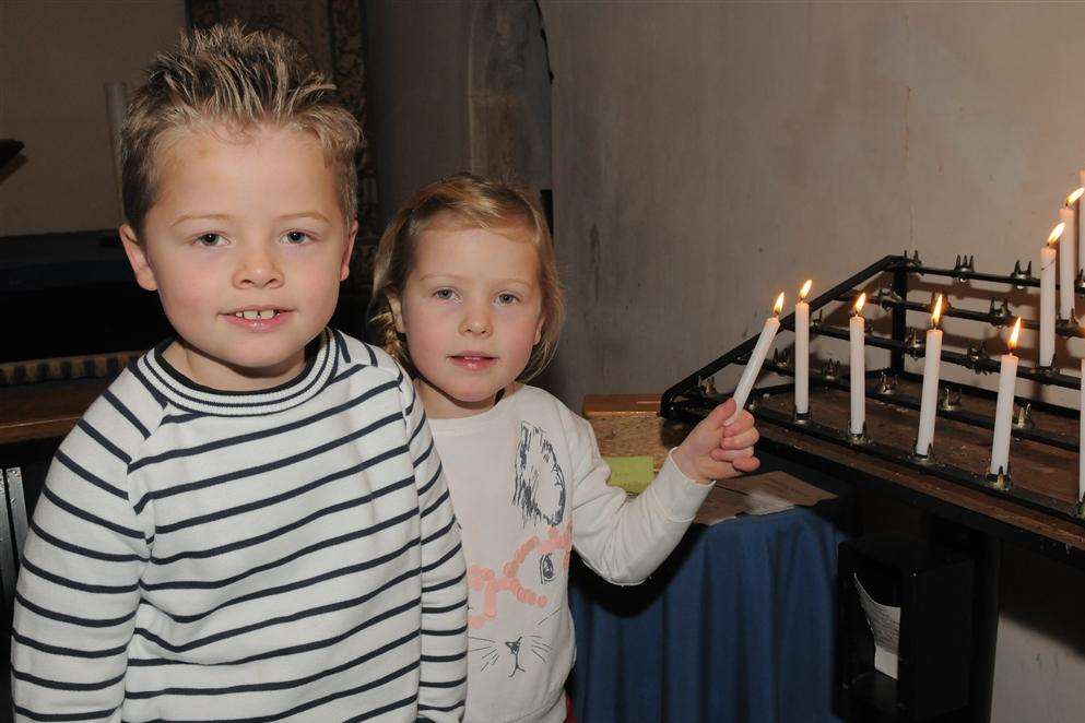 Christingle service at the Church of St Mary Magdalene, The Street, Cobham with Tom, six, and Ava, four.