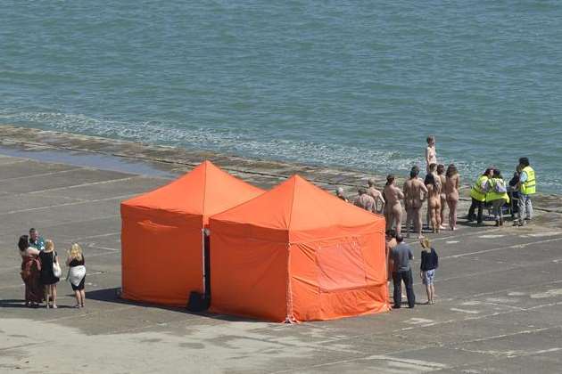Naked volunteers line up on the beach at The Warren in Folkestone for Spencer Tunick. Picture: Gary Browne