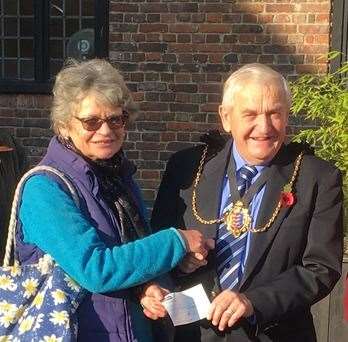 Sheila Ward from Deal Area Foodbank accepts a £3,000 grant from the Mayor of Sandwich Cllr Jeff Franklin