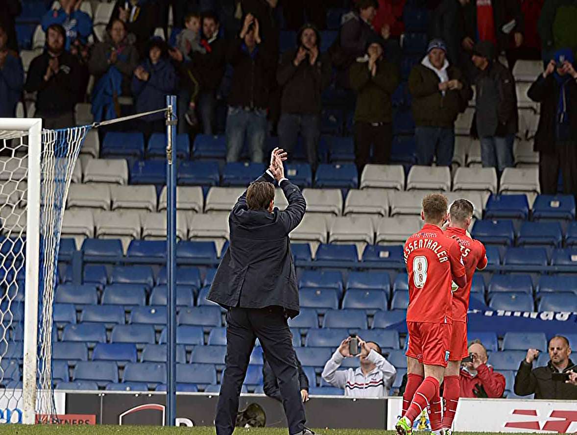 Gills boss Justin Edinburgh salutes the away crowd at Bury Picture: Barry Goodwin
