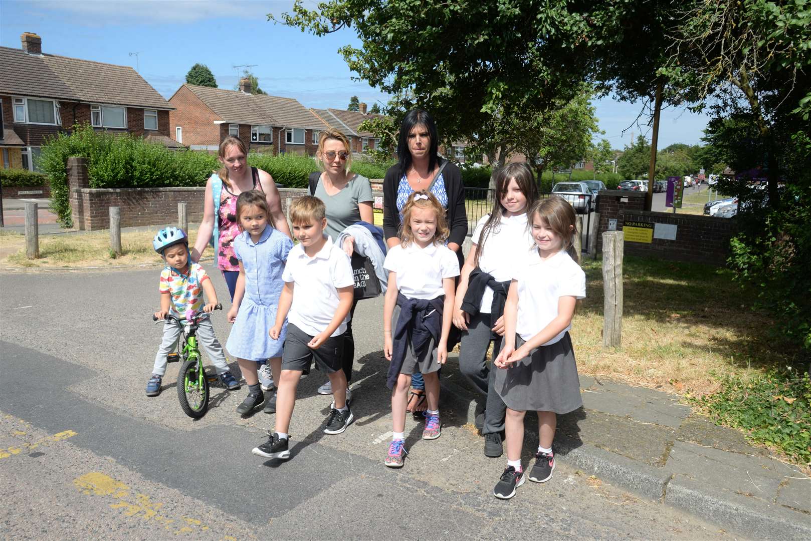 Petition organiser Sarah Sikkes and her children Rebecca, eight and Nathan, four on left and other parents and children cross Hollow Lane outside Wincheap School. Picture: Chris Davey... (2986317)