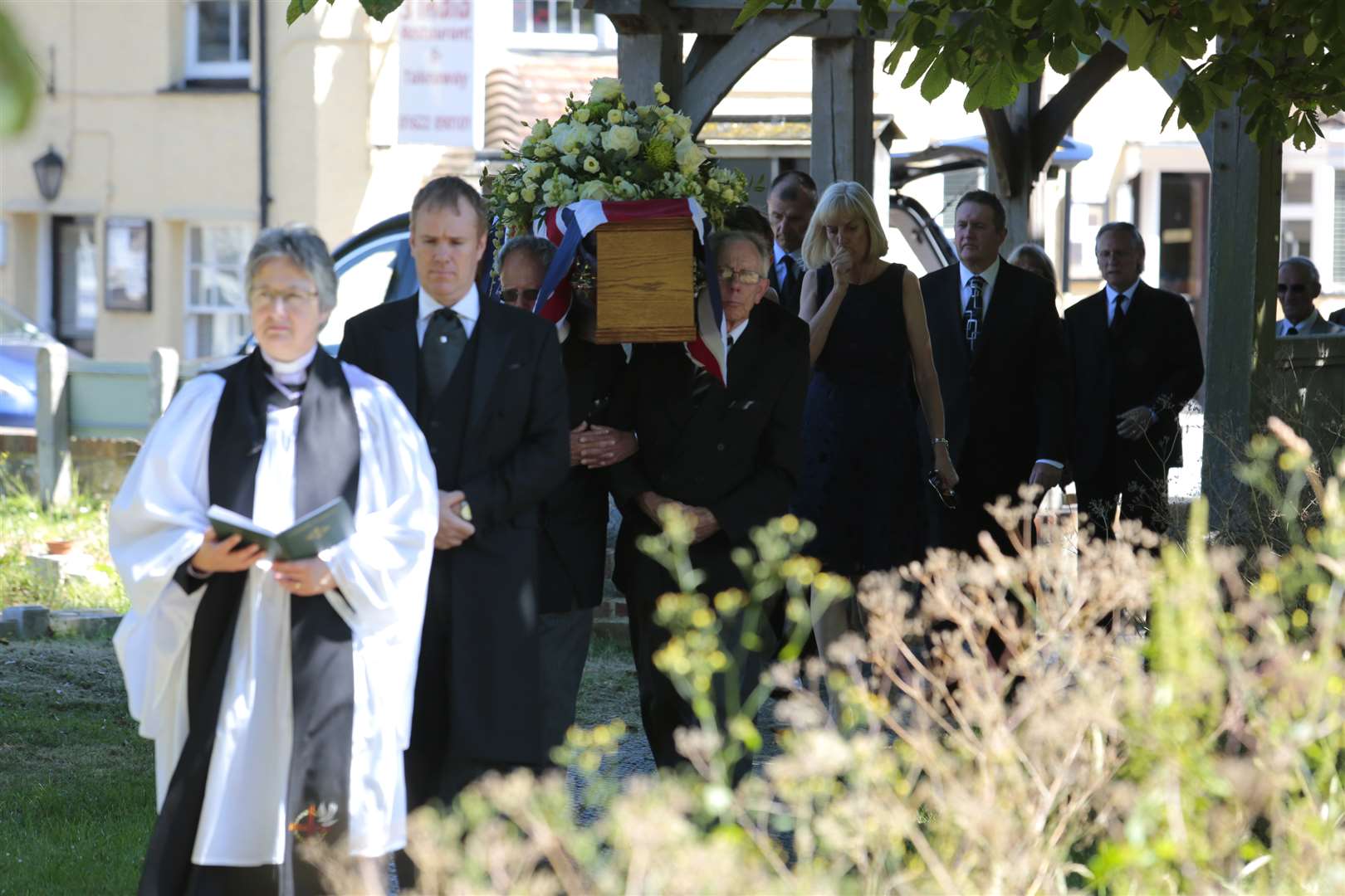 The Rev Fiona Haskett leads the coffin into the church